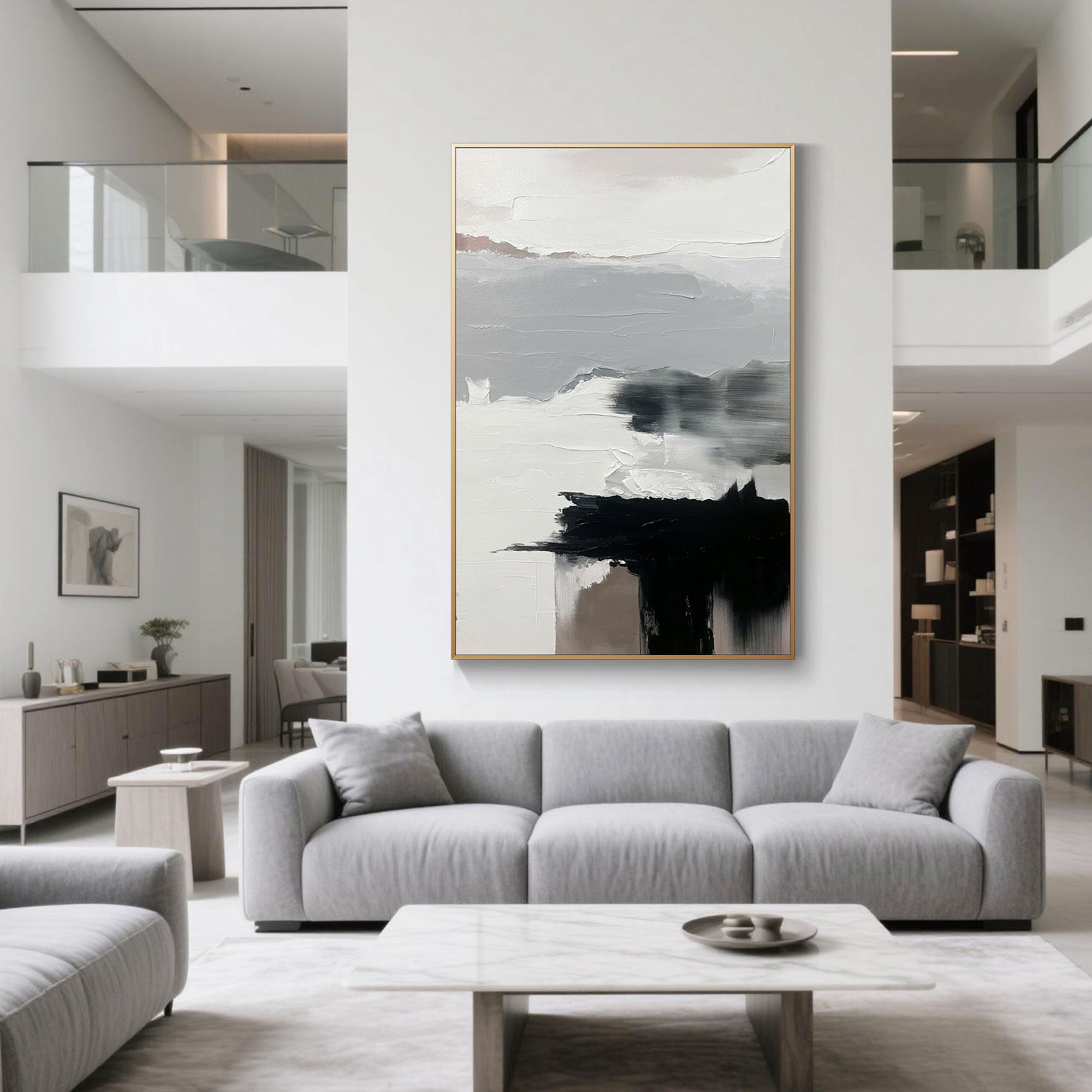 Tall Abstract Wall Art in black, grey, and white placed in a bright open space above a grey couch in a high-ceiling apartment