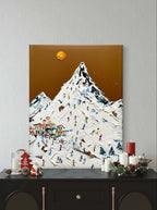 Hand-painted textured wall art depicting a vibrant ski resort scene with a snowy mountain, colorful skiers, and a golden sun.