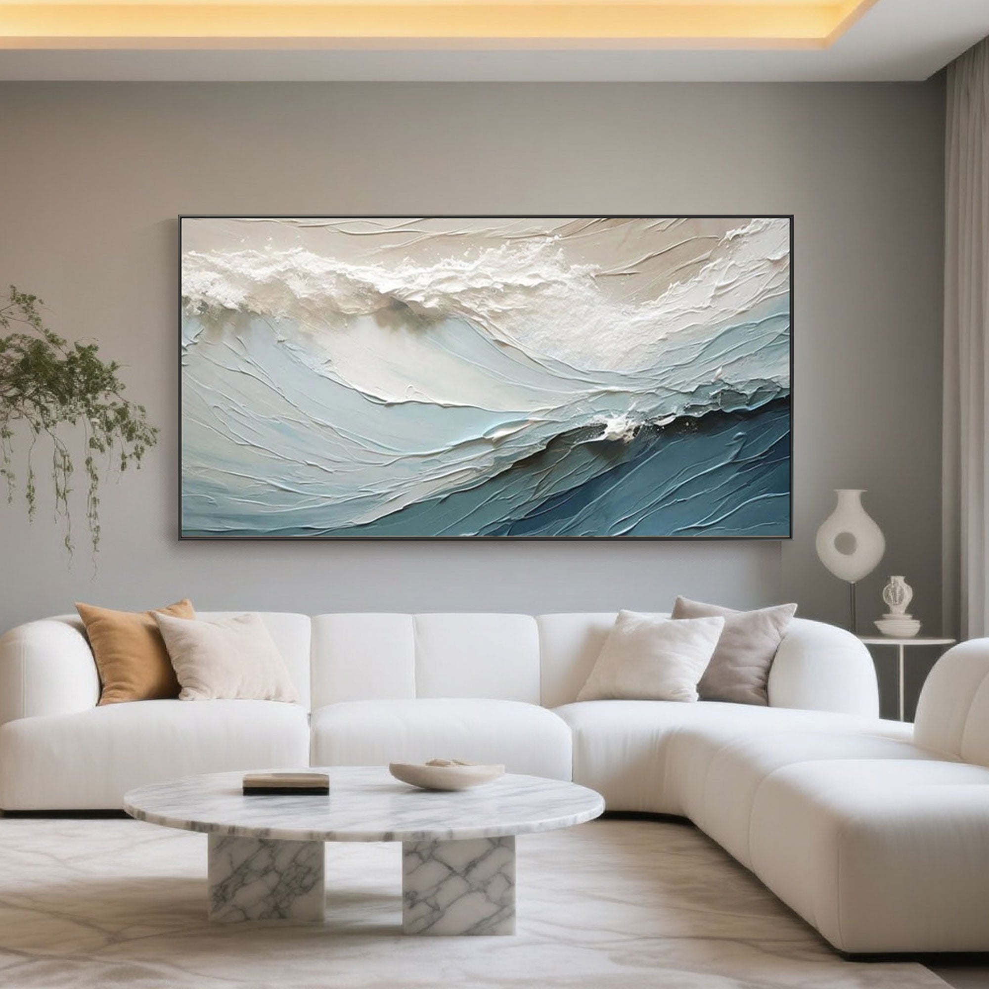 Blue seascape art 'Ocean Veil' above a white sofa in a modern living room.