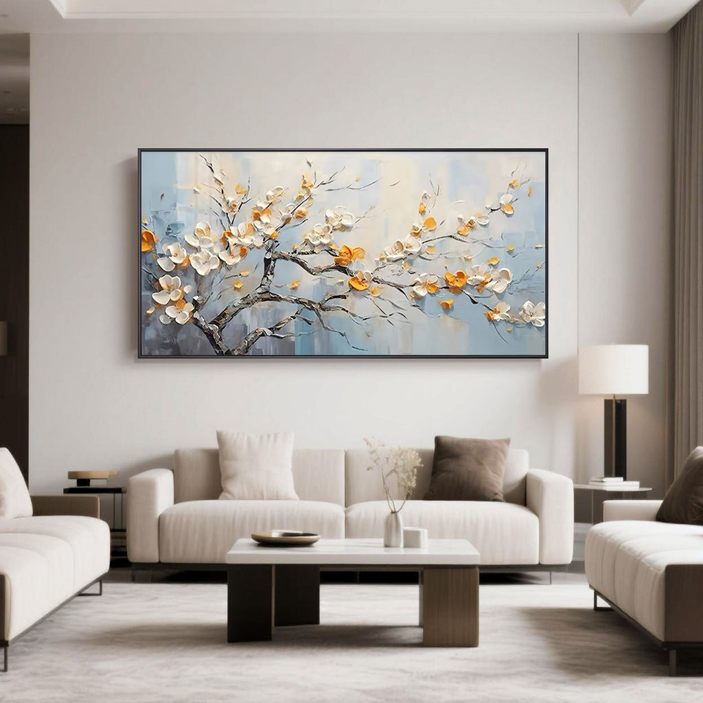 Elegant living room with framed hand-painted floral art; cream, gold blossoms on blue background.