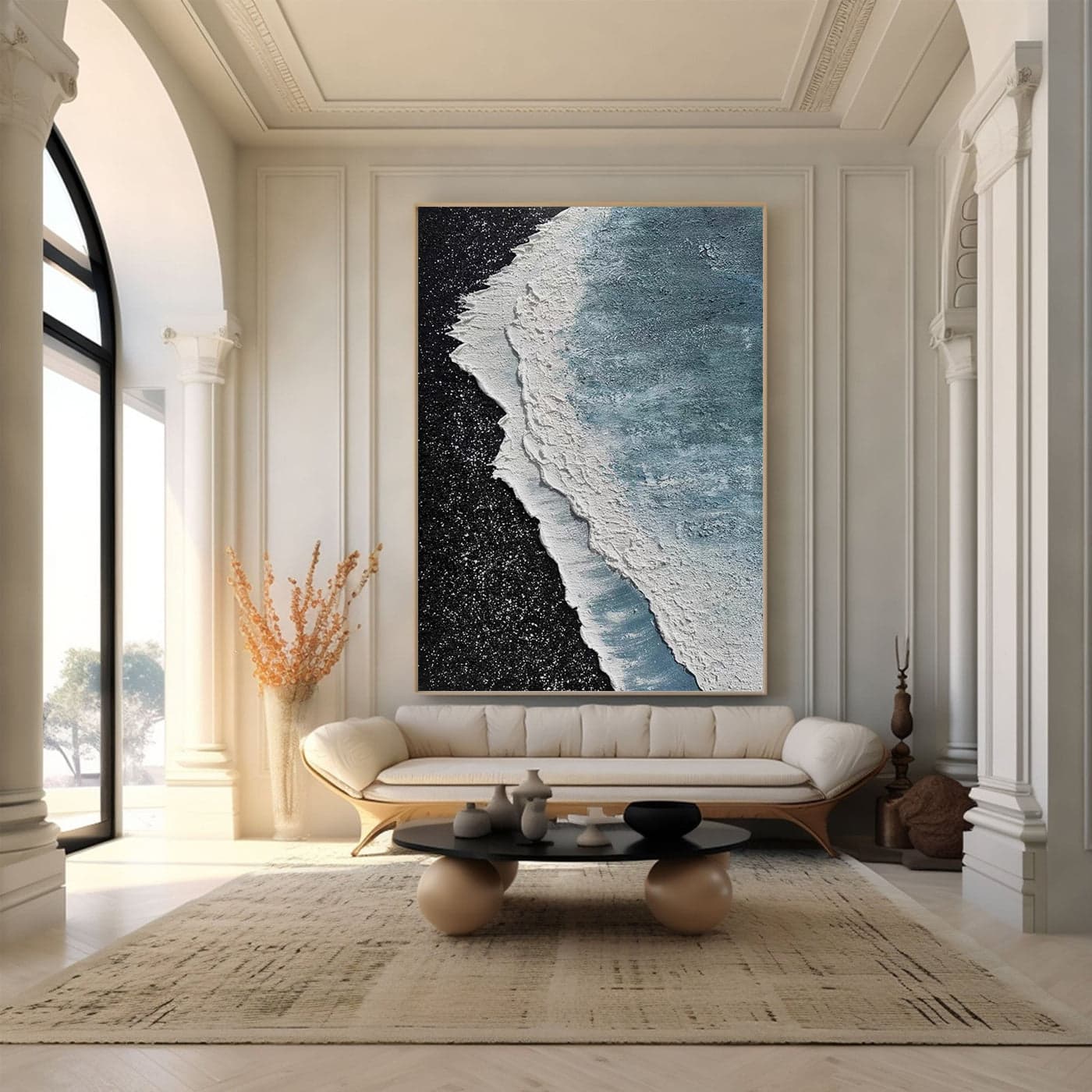 Textured ocean canvas art above sofa in bright living room.