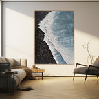 3D ocean art in living room, textured blue waves, black shore.
