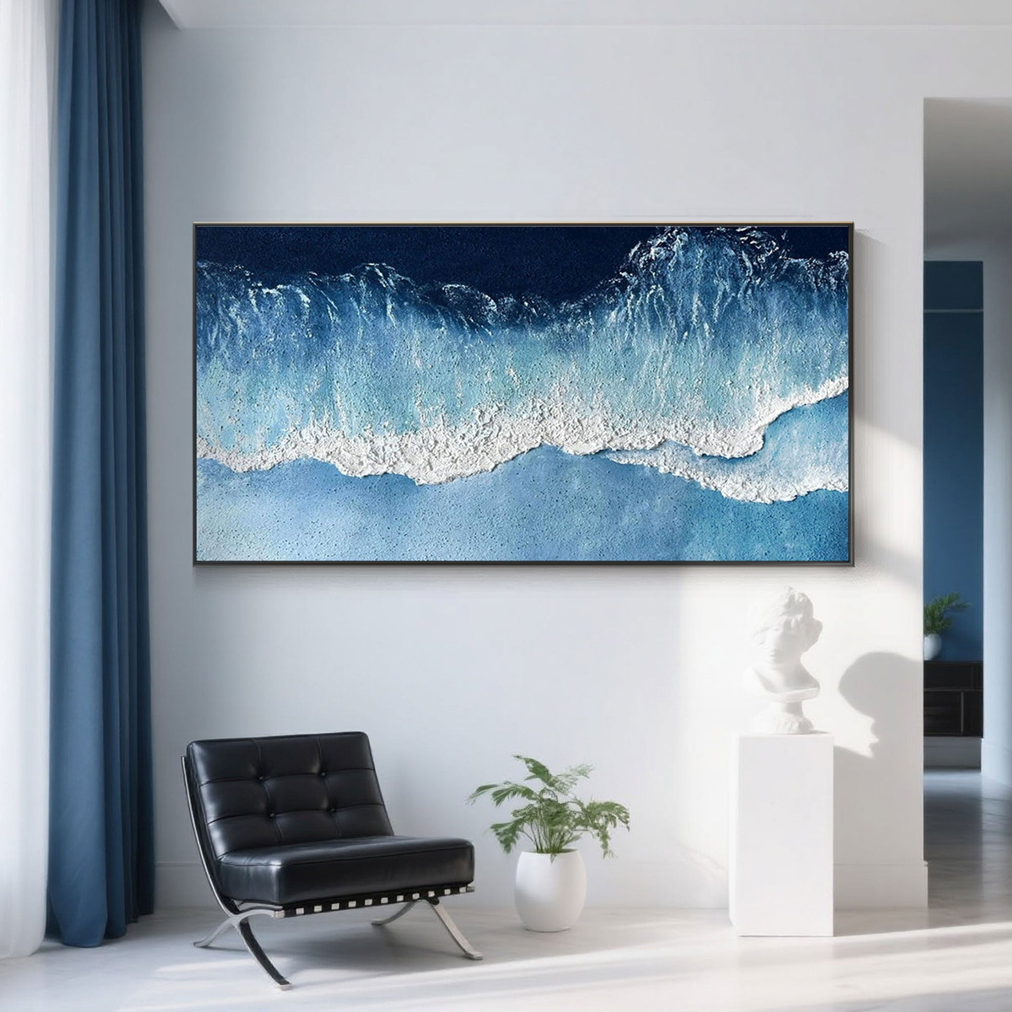 Textured ocean wave painting hung in a modern interior.