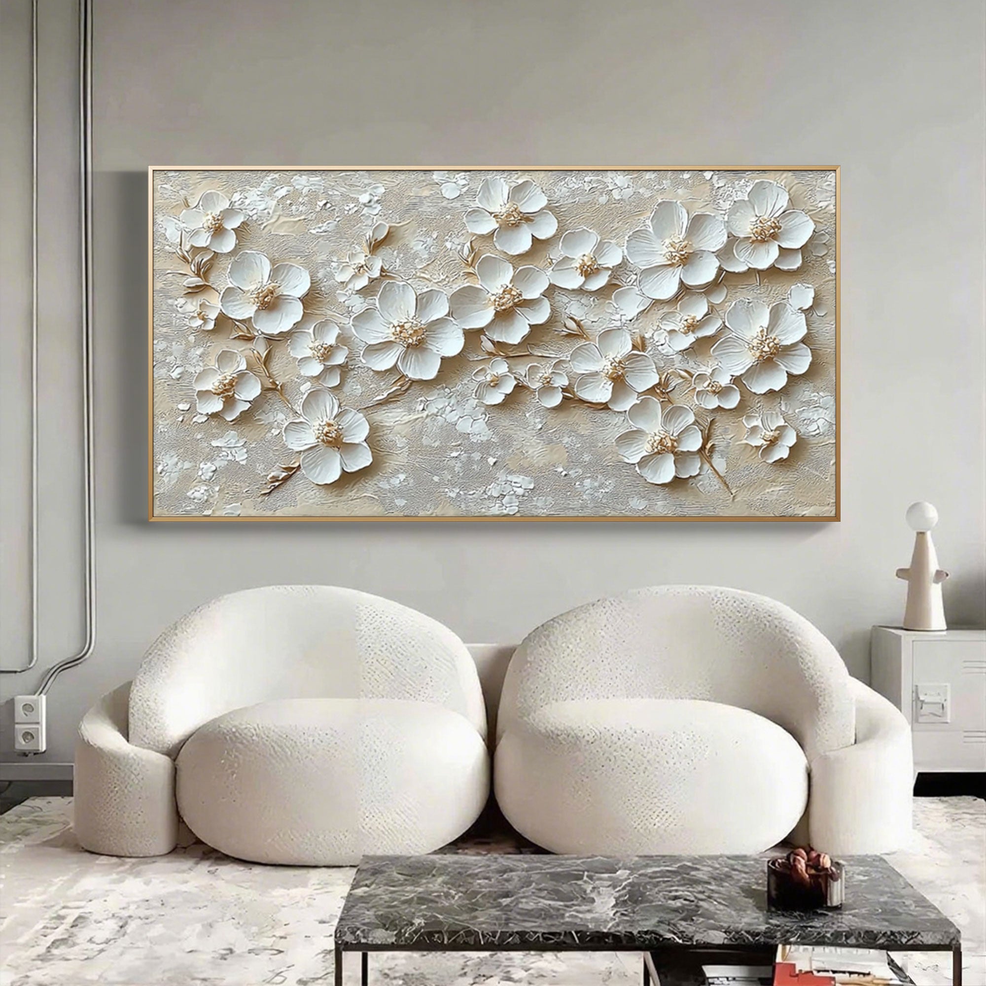 Modern living room featuring 3D floral beige wall art above white chairs.