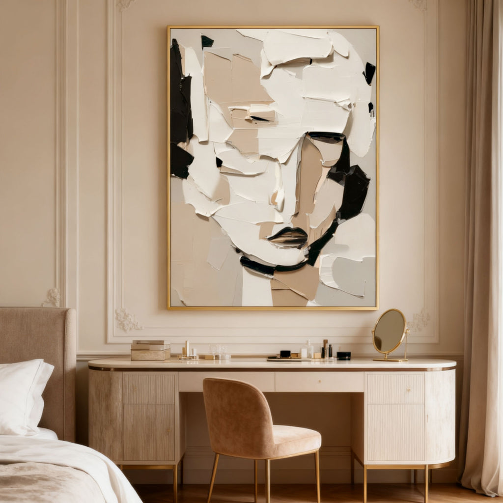 Hand-painted 3D textured abstract modern portrait wall art in white, beige, and black with gold frame, displayed above a bedroom vanity with a round mirror and soft neutral decor.