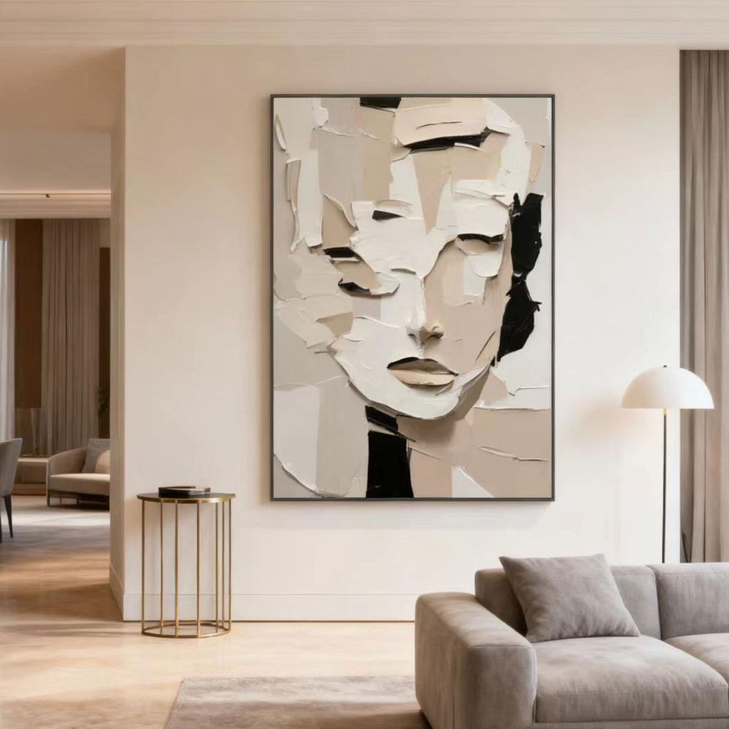 3D textured abstract portrait canvas art 'Quiet Within' in beige, white, and black hues, displayed in a modern living room with neutral tones.