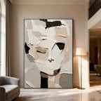 3D textured abstract portrait canvas art 'Silent Self' with thick paint strokes in white, beige, black, and gray, displayed in a modern living room.