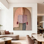 3D textured abstract portrait wall art in soft pinks/beiges at Lumi Gallery living room