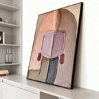 Hand-painted abstract portrait wall art with textured details, soft pastels, black frame, modern interior.