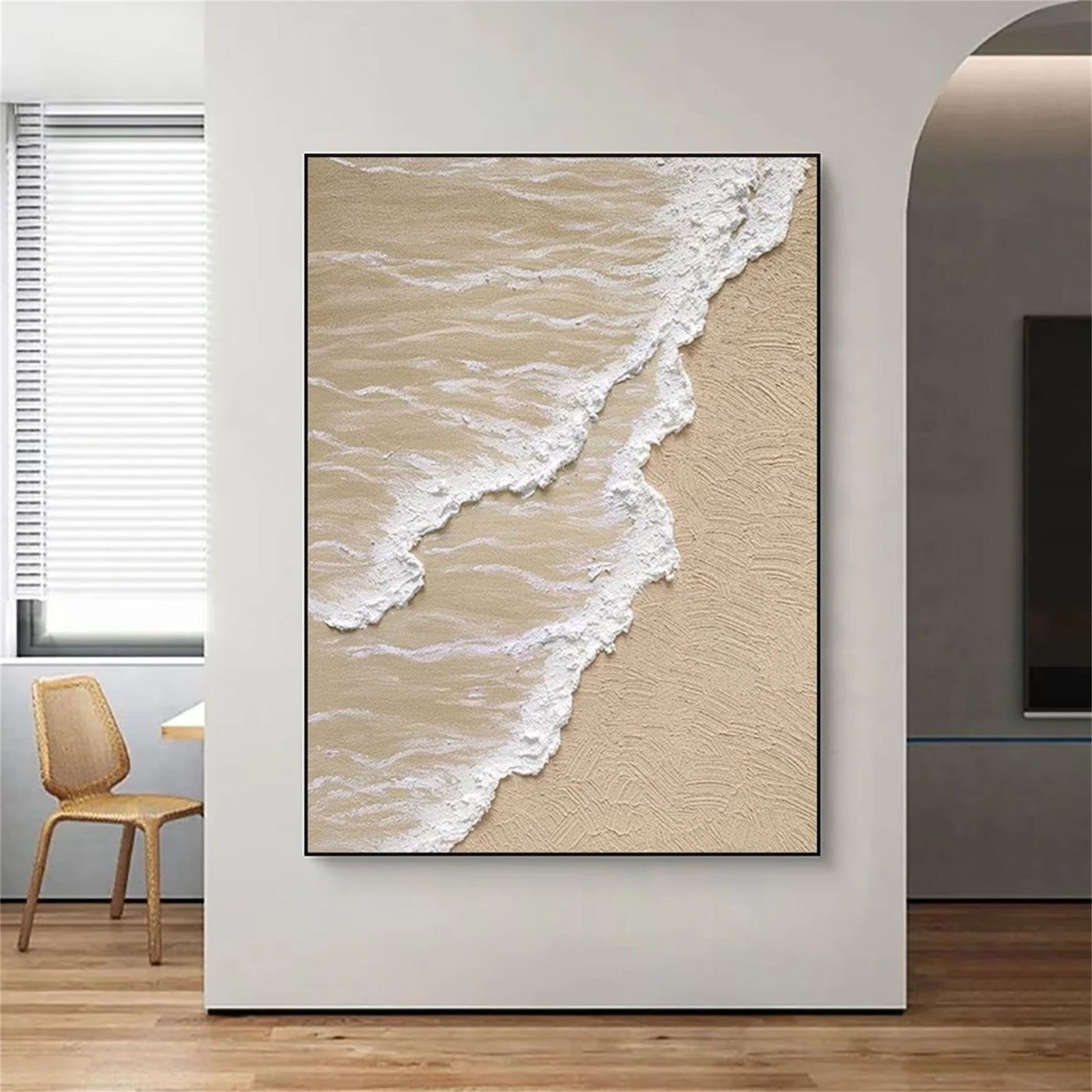 Beige and white 3D ocean wave canvas art in a modern living room.