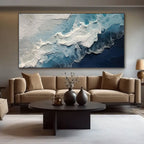 Textured ocean wave canvas art in a living room setting.
