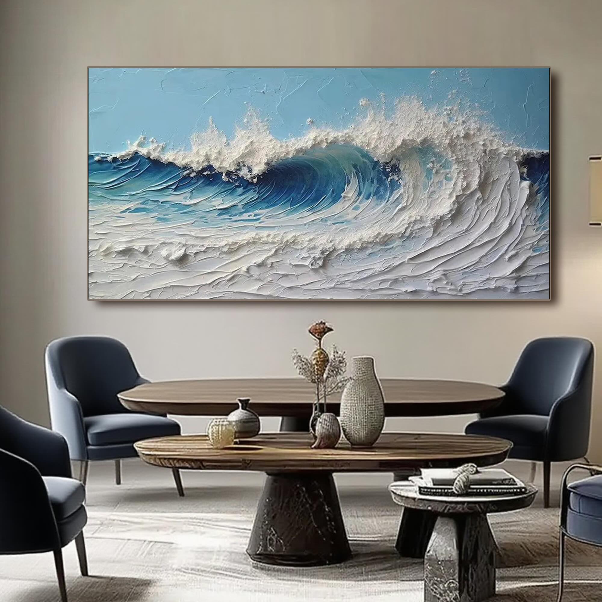 3D ocean wave art above a table in a stylish living room with blue chairs.
