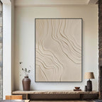 Abstract wall art with wavy patterns in a modern interior setting.