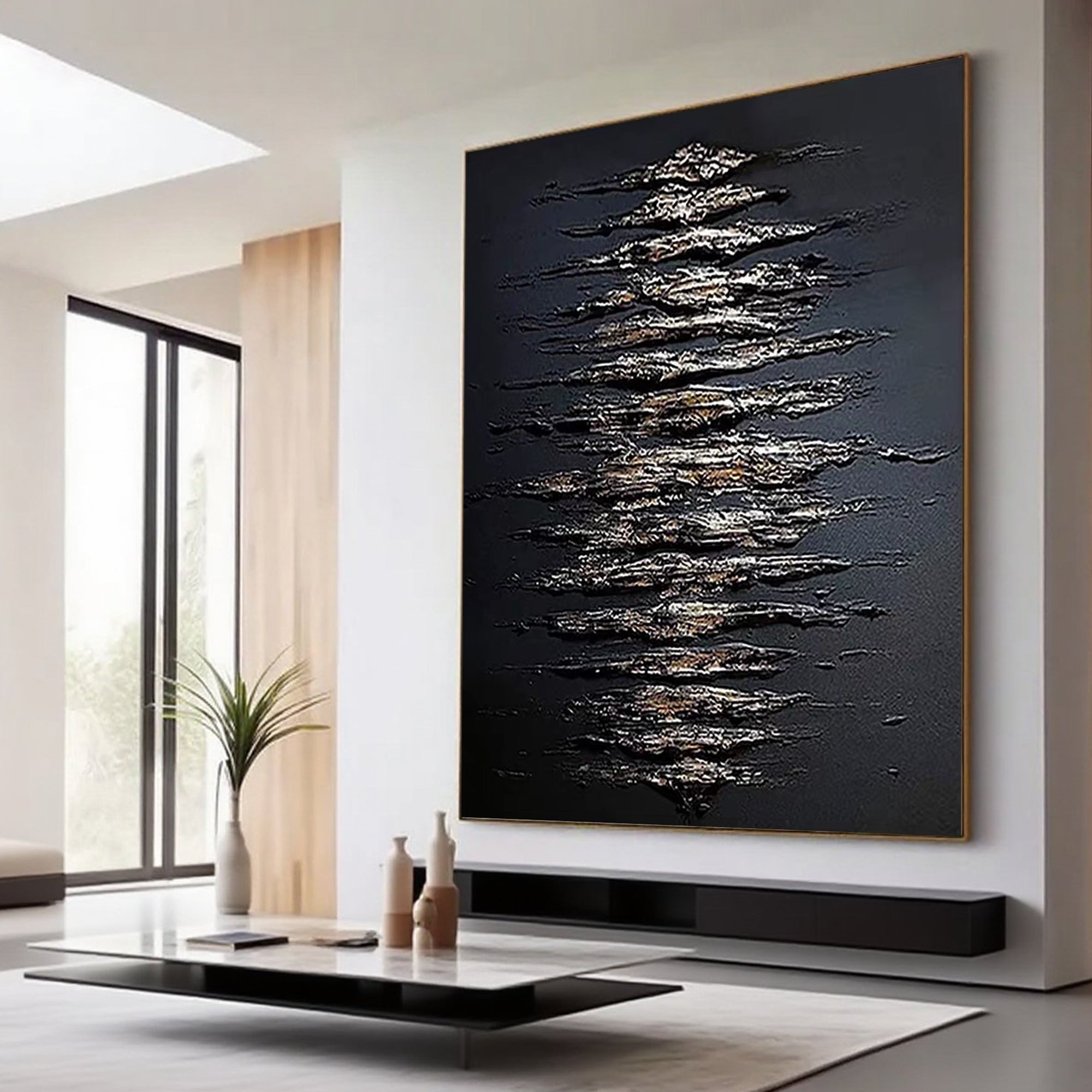 3D textured abstract wall art 'Scale Chant' with black canvas and metallic gold/silver streaks, framed in thin gold, displayed in modern living room setting.