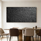 Lumi Gallery's 3D textured black abstract wall art 'Obsidian Field' mounted on white wall over dining set