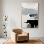 Large Abstract Wall Art in black and white showcased in a minimalist sitting area with curved lighting and a warm-toned rug