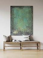 Green and blue textured painting styled vertically in a minimalist space