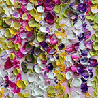 Close-up of textured floral painting with vibrant pink, purple, green, and yellow hues.