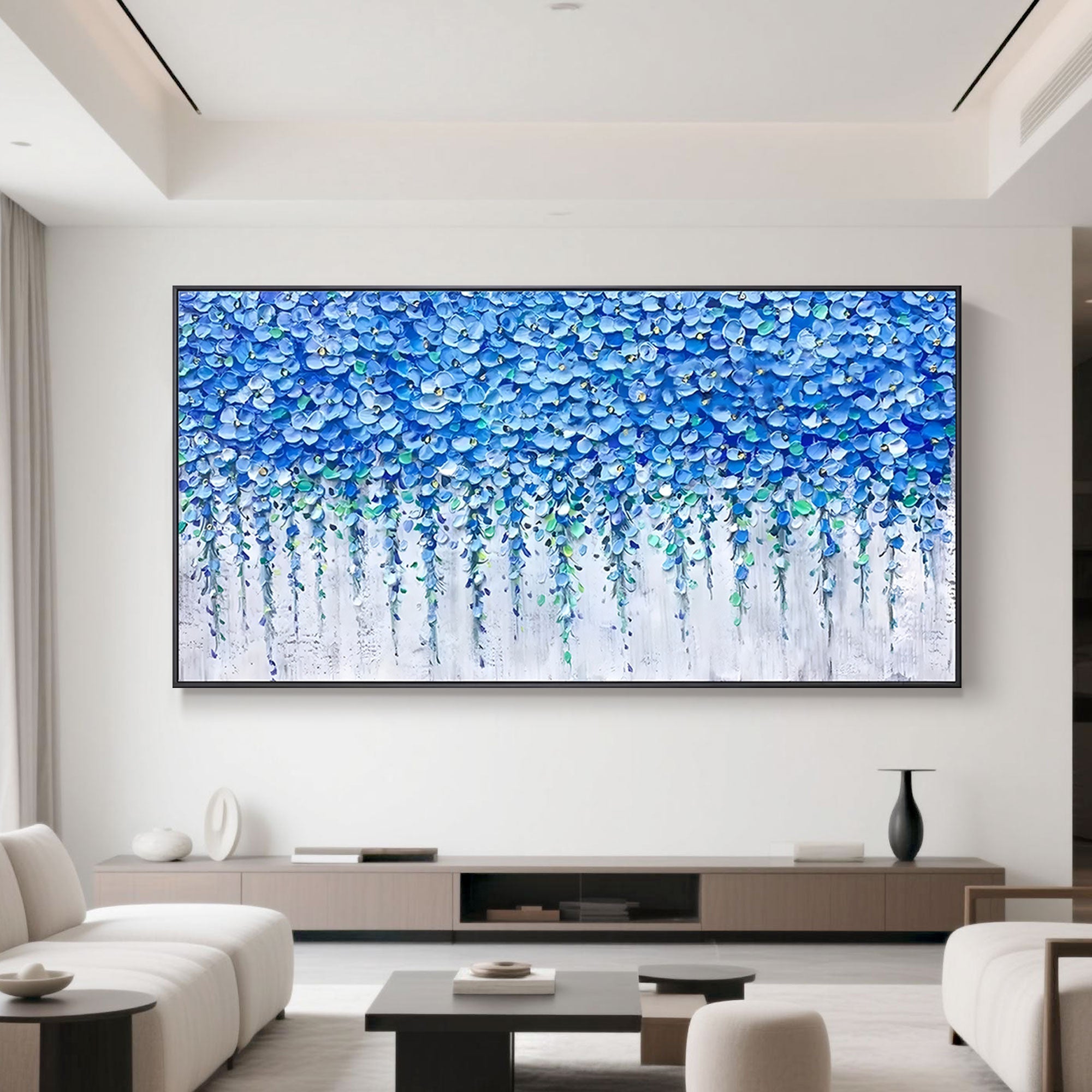 Blue floral wall art in modern white living room setting.