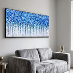 Blue floral art brightening a gray seating area with botanical elegance.