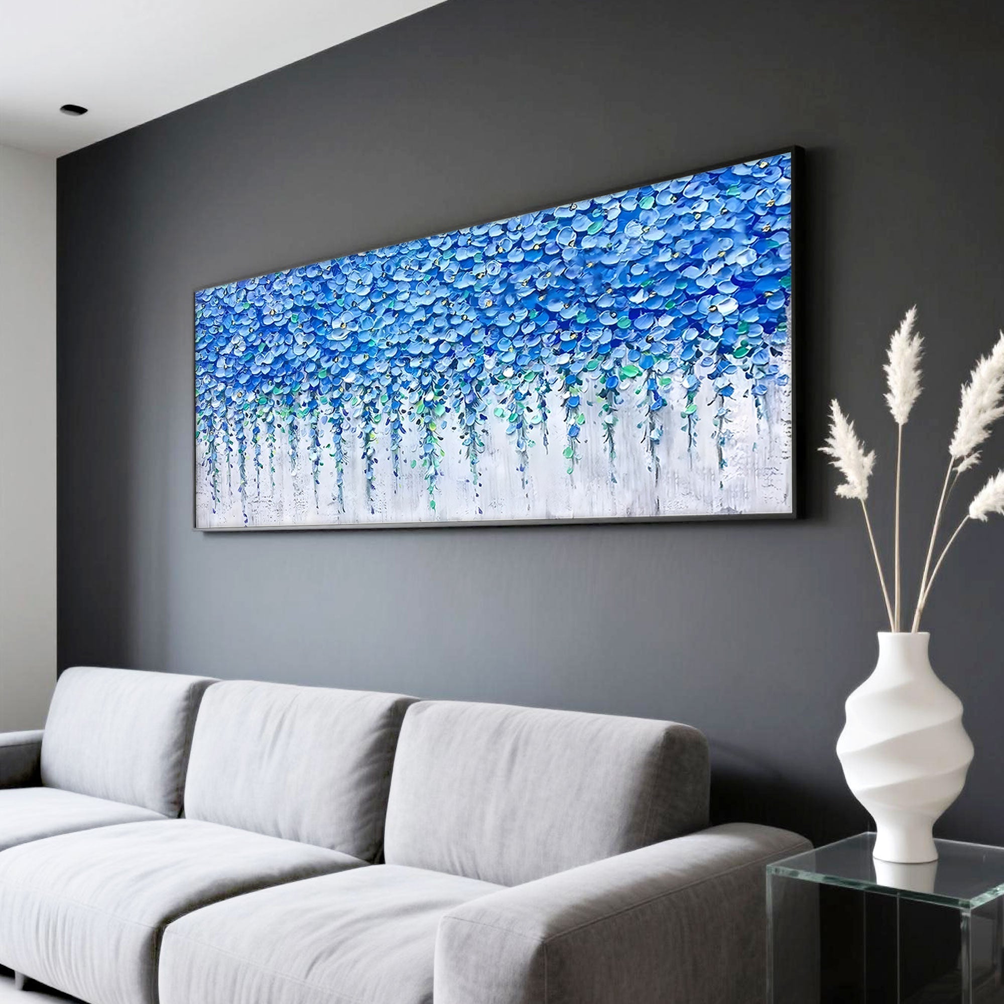 Blue floral art on dark wall in living room with gray sofa.
