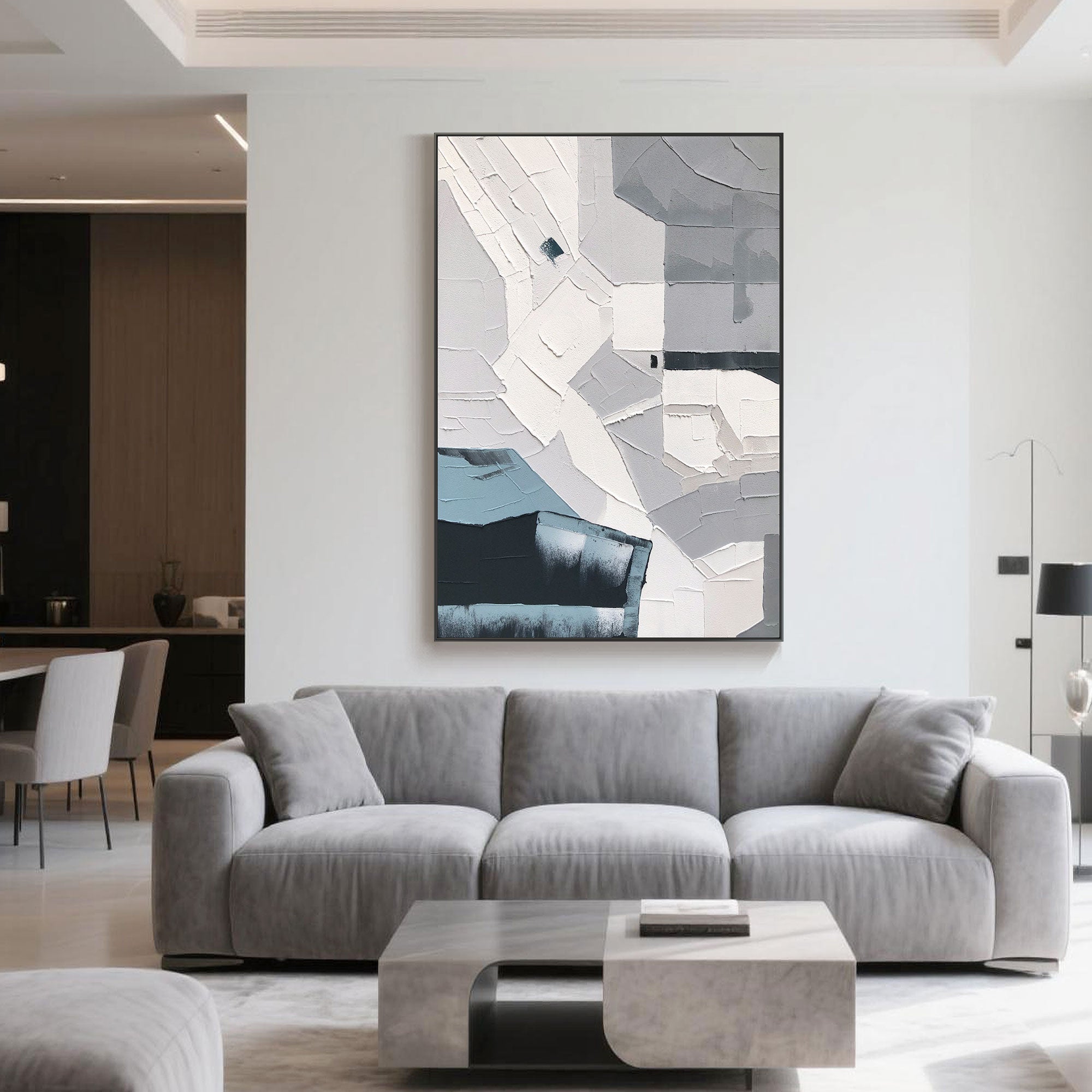 Abstract geometric canvas art in a contemporary living room above a grey sofa.