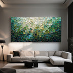 Green mosaic art in a modern living room with a neutral sofa and black accents.