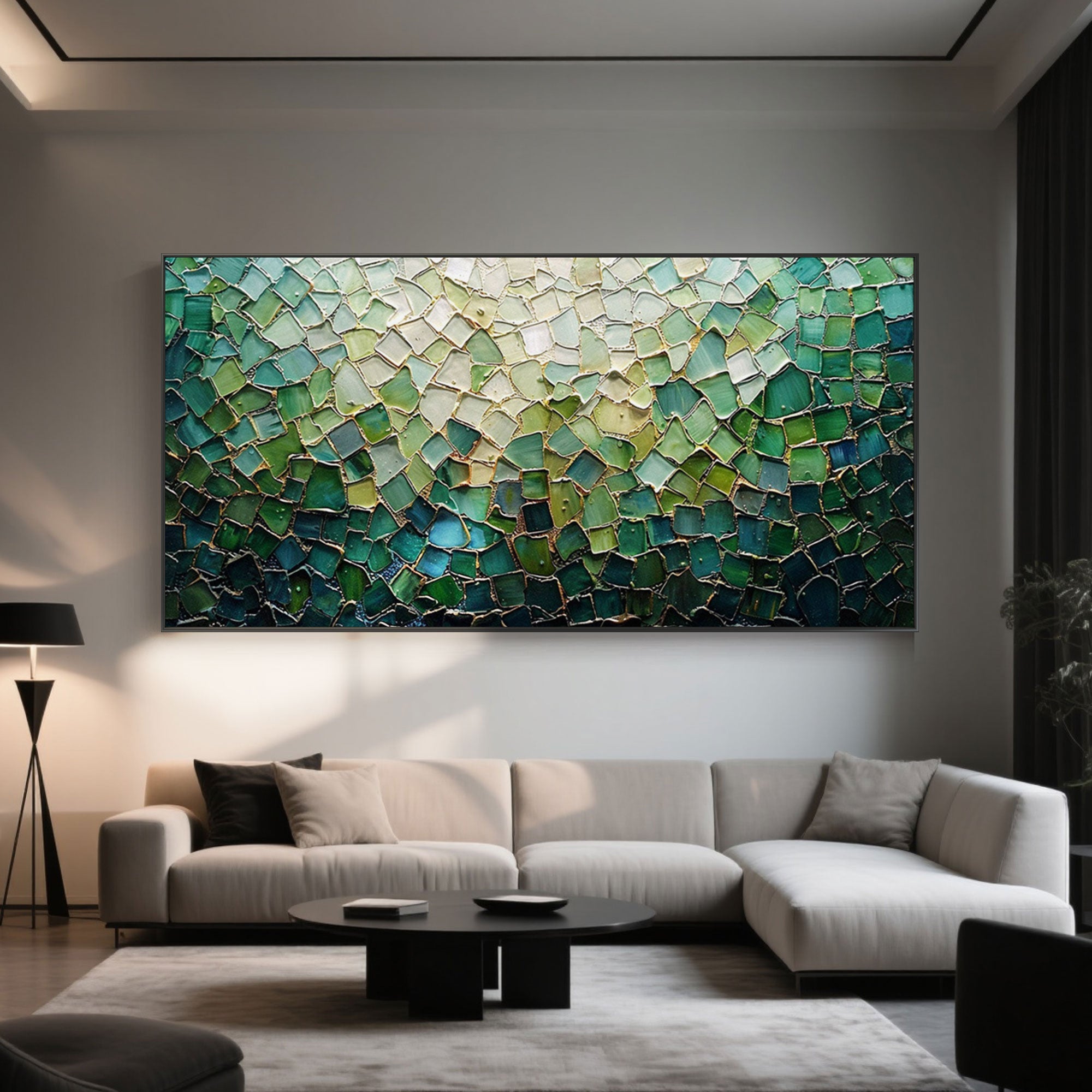 Green mosaic art in a modern living room with a neutral sofa and black accents.