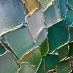 Close up of green mosaic wall art showing texture and color variations.