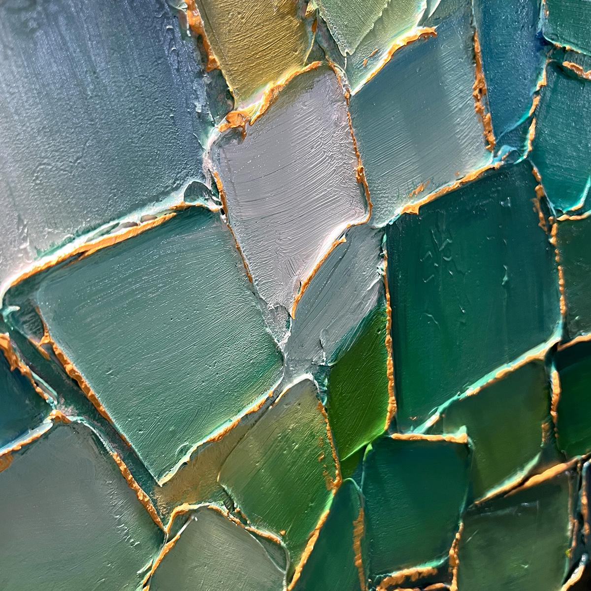 Close up of green mosaic wall art showing texture and color variations.