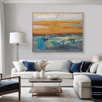 Abstract dusk art above sofa. Modern living room with blue and gold canvas.