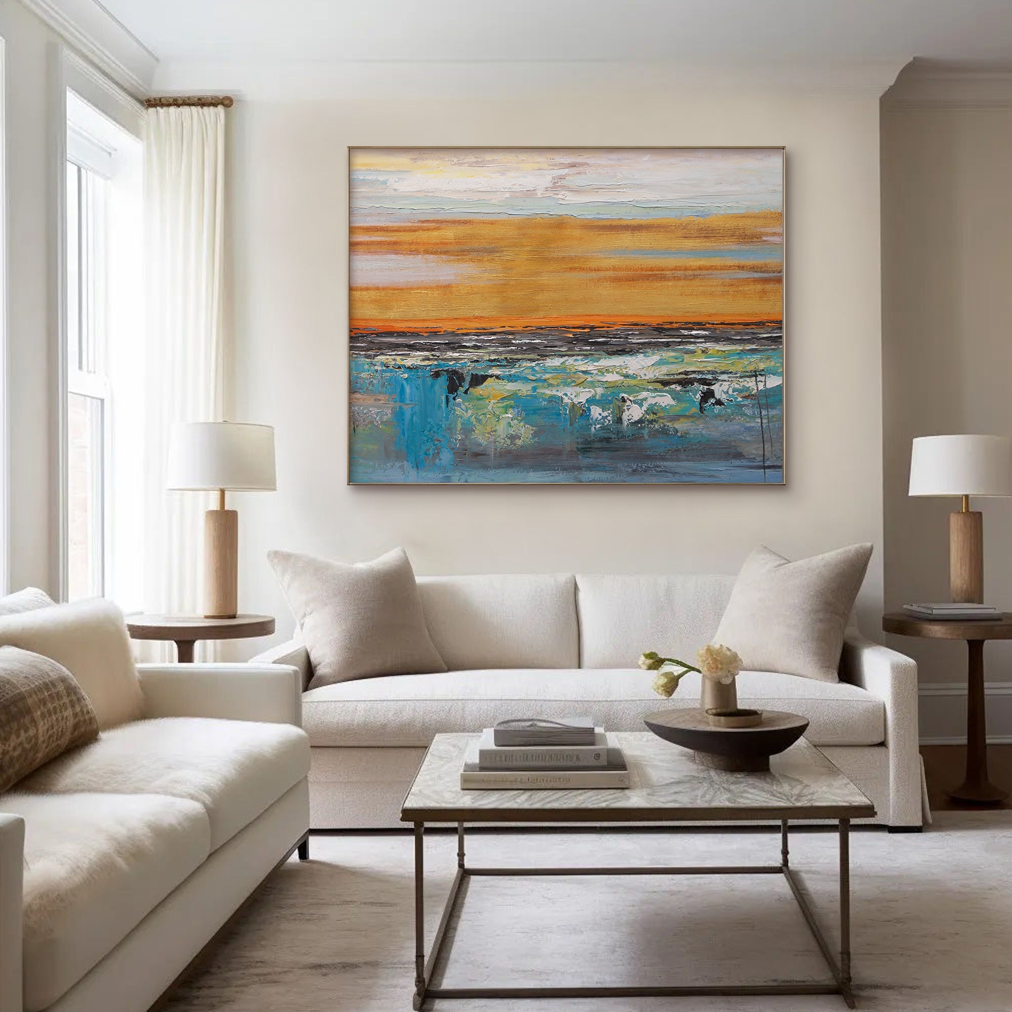 Abstract landscape art in living room. Golden and blue canvas above a white sofa.