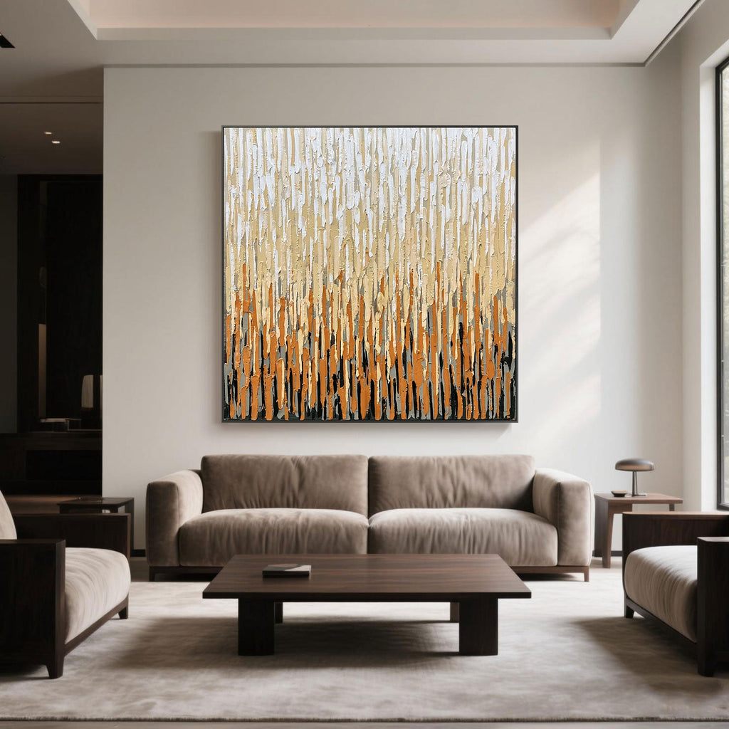 Square canvas art in creamy and caramel colors in a cozy neutral living space.