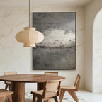 Abstract minimalist vintage wall art 'Drift of Light' with textured dark gray canvas, modern dining room display at Lumi Gallery