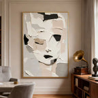 Abstract modern portrait canvas art with fragmented style, neutral tones, gold frame in stylish living room