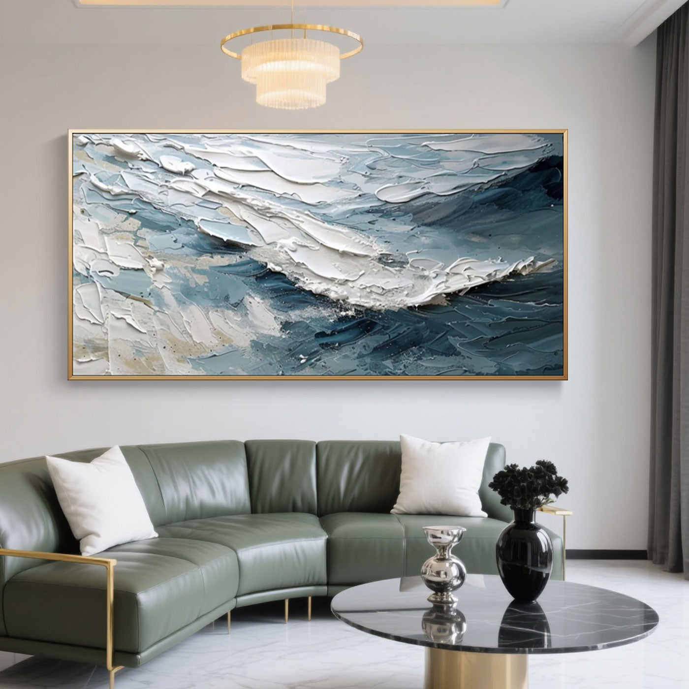 Abstract Modern Wave Wall Art – Breakwave: Hand-painted canvas with thick, textured blue, white, and gray waves in a gold frame, displayed in a modern living room with green sofa and marble coffee table.