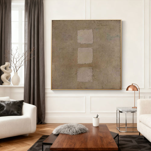 Wabi-Sabi Geometric Wall Art - Earthen Sequence: Hand-painted canvas with three textured taupe squares on warm brown background, gold frame, displayed in modern living room.