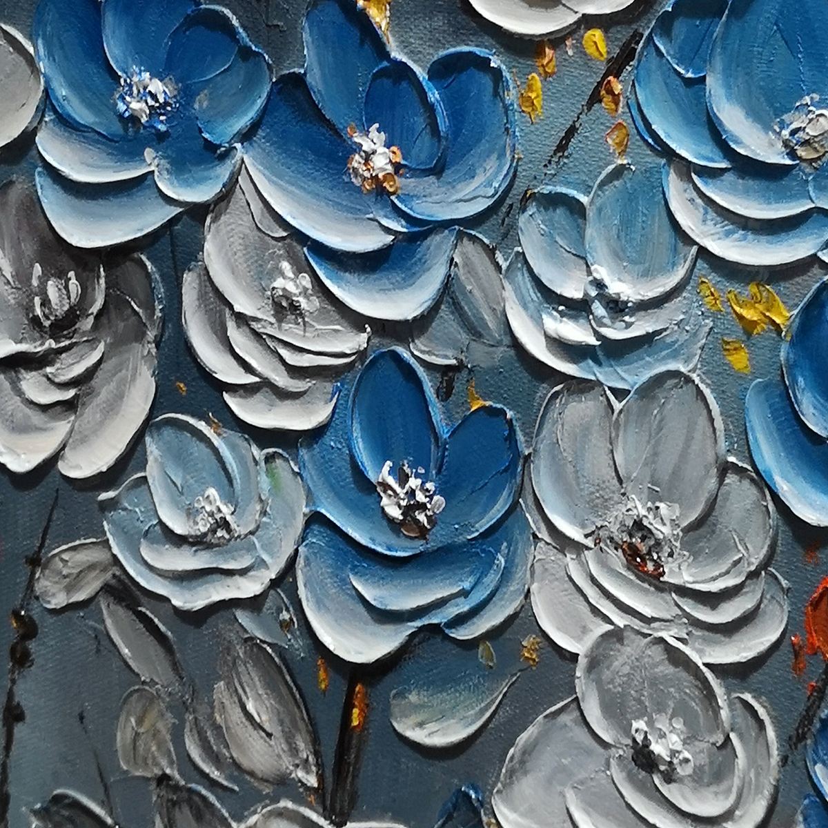 Close-up of blue and white 3D textured flower petals on canvas art.