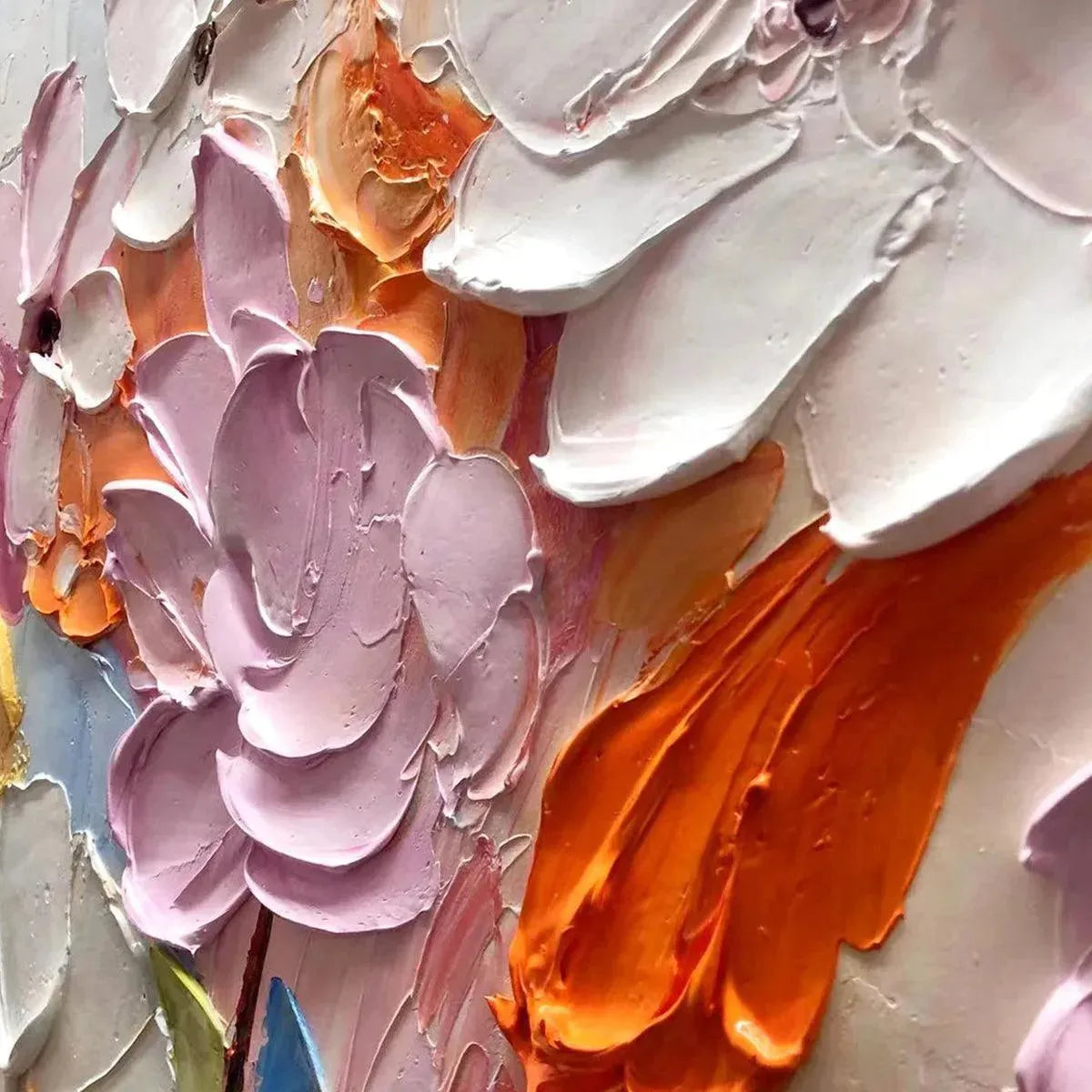 Close-up of thick textured acrylic and oil paint forming abstract flowers.