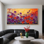 Floral art above black sofa in living room.