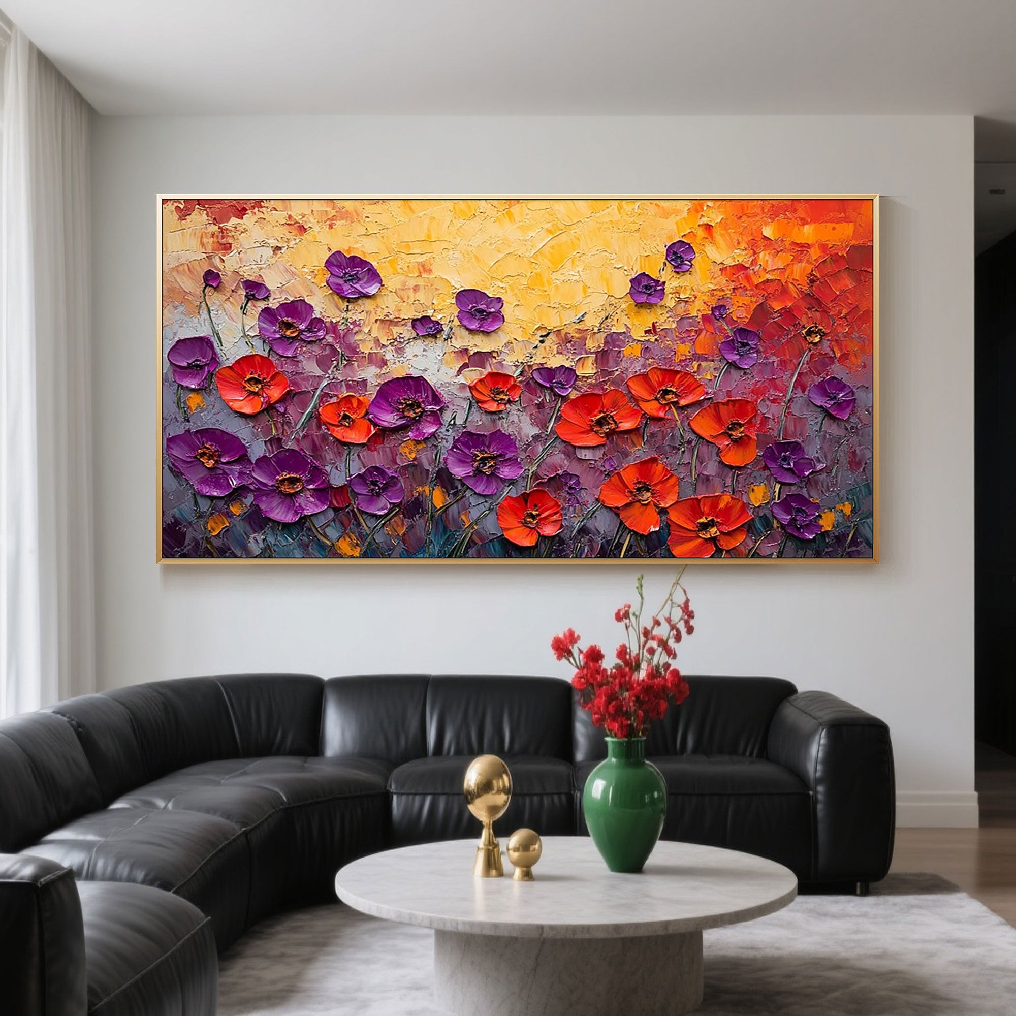 Floral art above black sofa in living room.