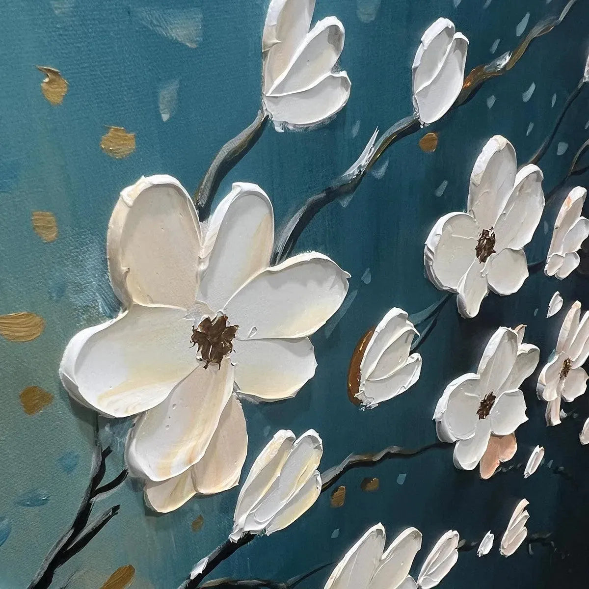 Close-up of textured white flower petals on a teal and gold canvas.