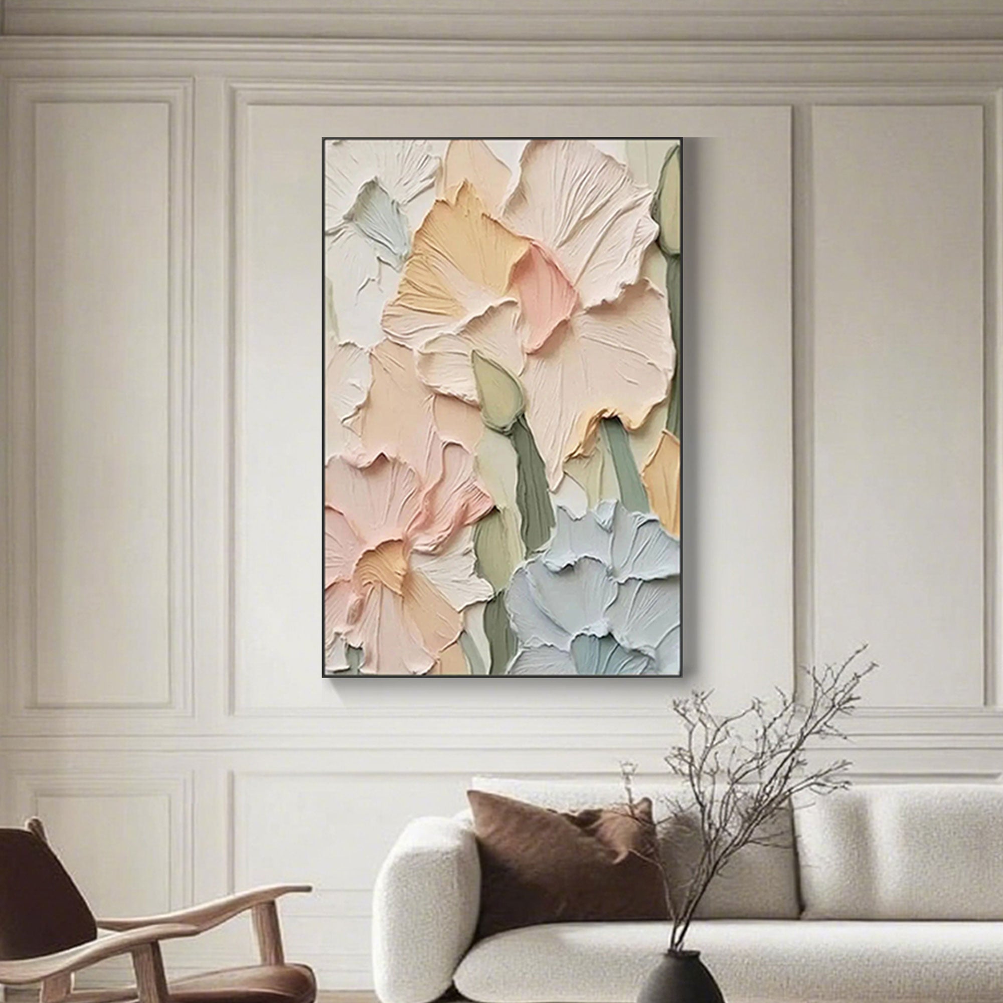 Textured floral painting with a black frame, mounted above a sofa.