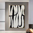 Black and white abstract line art, showcasing minimalist style, with black lines weaving across a white background, adding an artistic touch to modern interiors.
