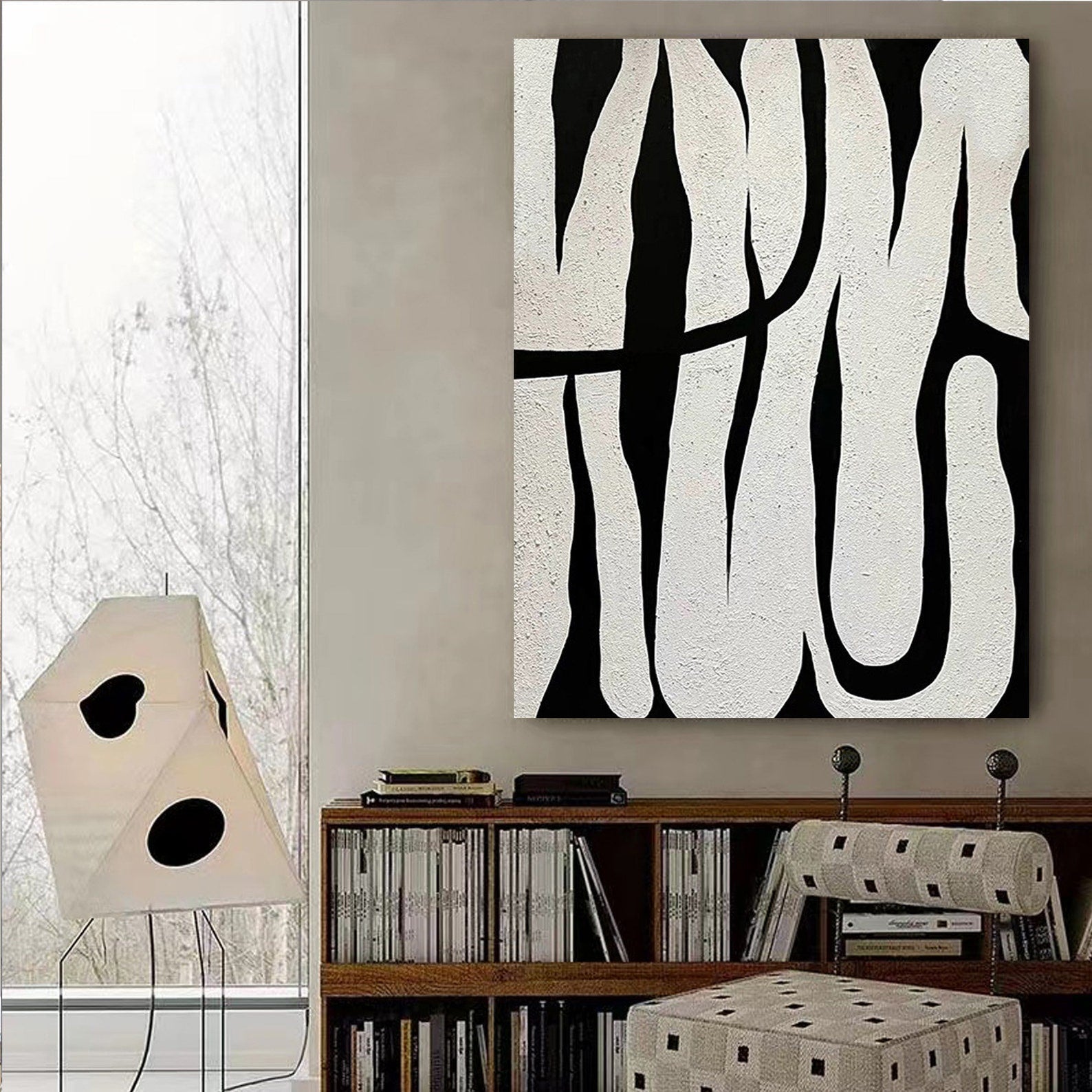 Black and white abstract line art, showcasing minimalist style, with black lines weaving across a white background, adding an artistic touch to modern interiors.