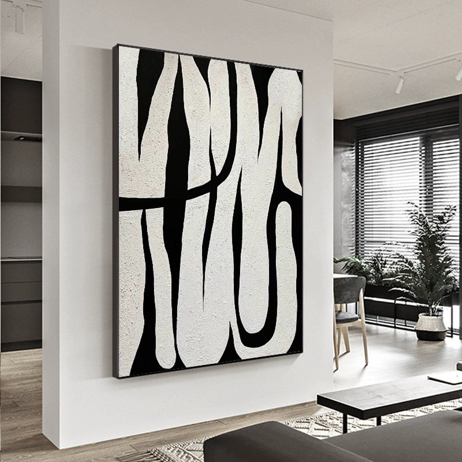 Black and white abstract line art, showcasing minimalist style, with black lines weaving across a white background, adding an artistic touch to modern interiors.