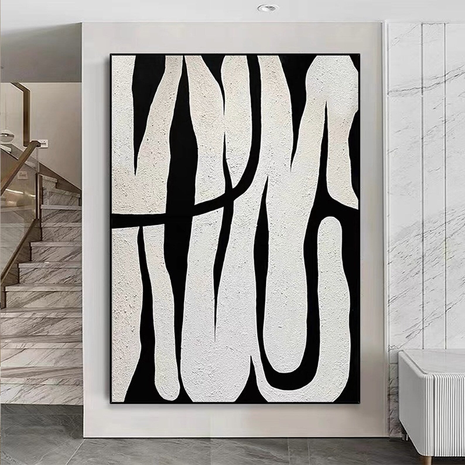 Black and white abstract line art, showcasing minimalist style, with black lines weaving across a white background, adding an artistic touch to modern interiors.