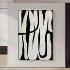 Black and white abstract line art, showcasing minimalist style, with black lines weaving across a white background, adding an artistic touch to modern interiors.