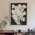 Vertical black and white canvas art with a subtle floral motif, blending minimalism and mid-century aesthetics.