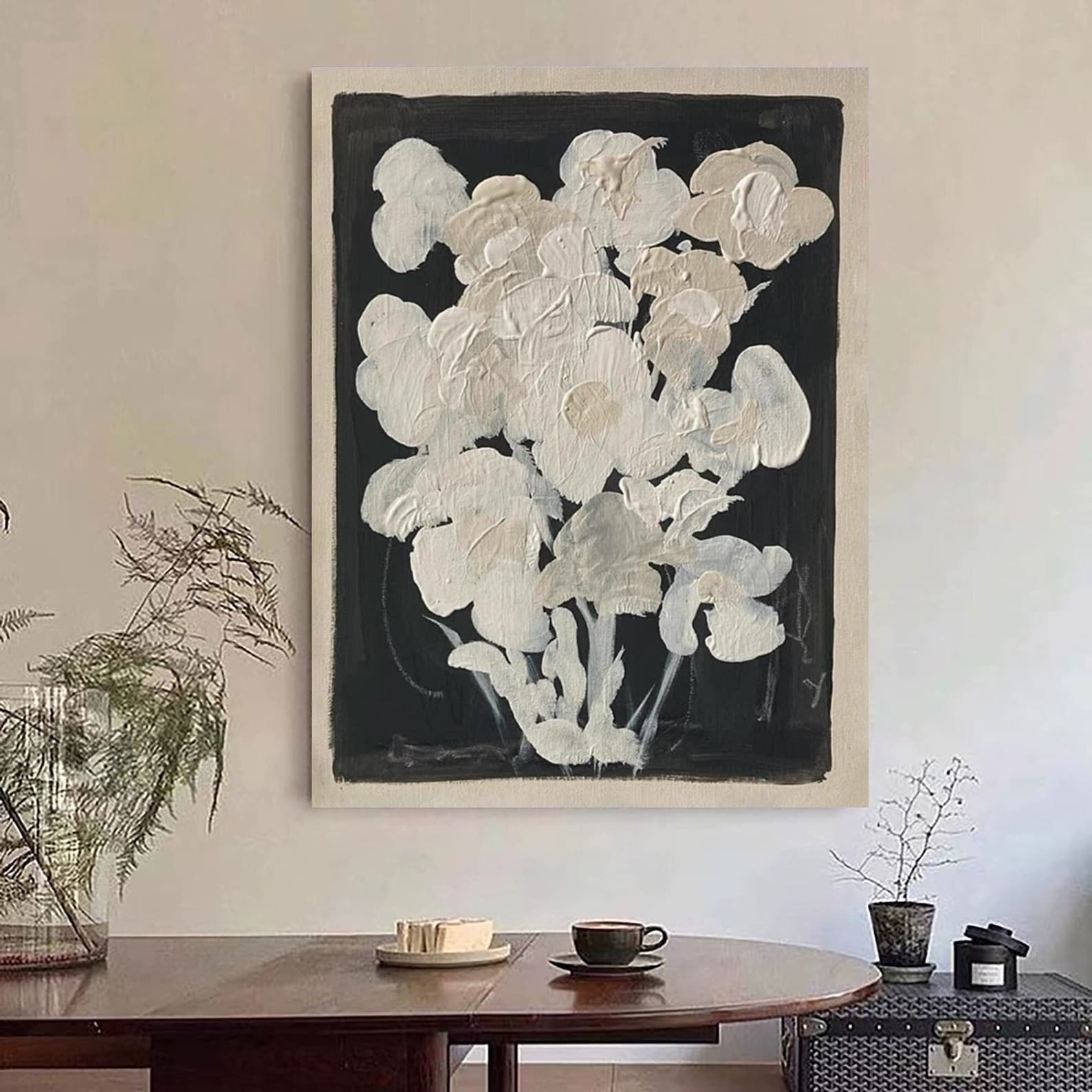 Vertical black and white canvas art with a subtle floral motif, blending minimalism and mid-century aesthetics.